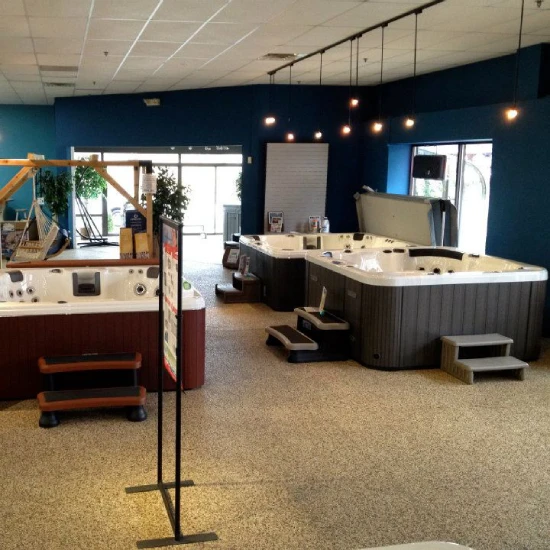 Interior of a hot tub store displaying multiple hot tubs and spa models in a spacious, well-lit setting.