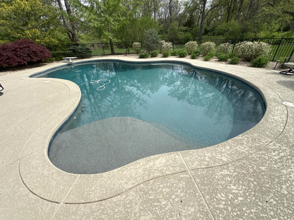Well-maintained in-ground swimming pool featuring clean water and smooth deck surfaces.